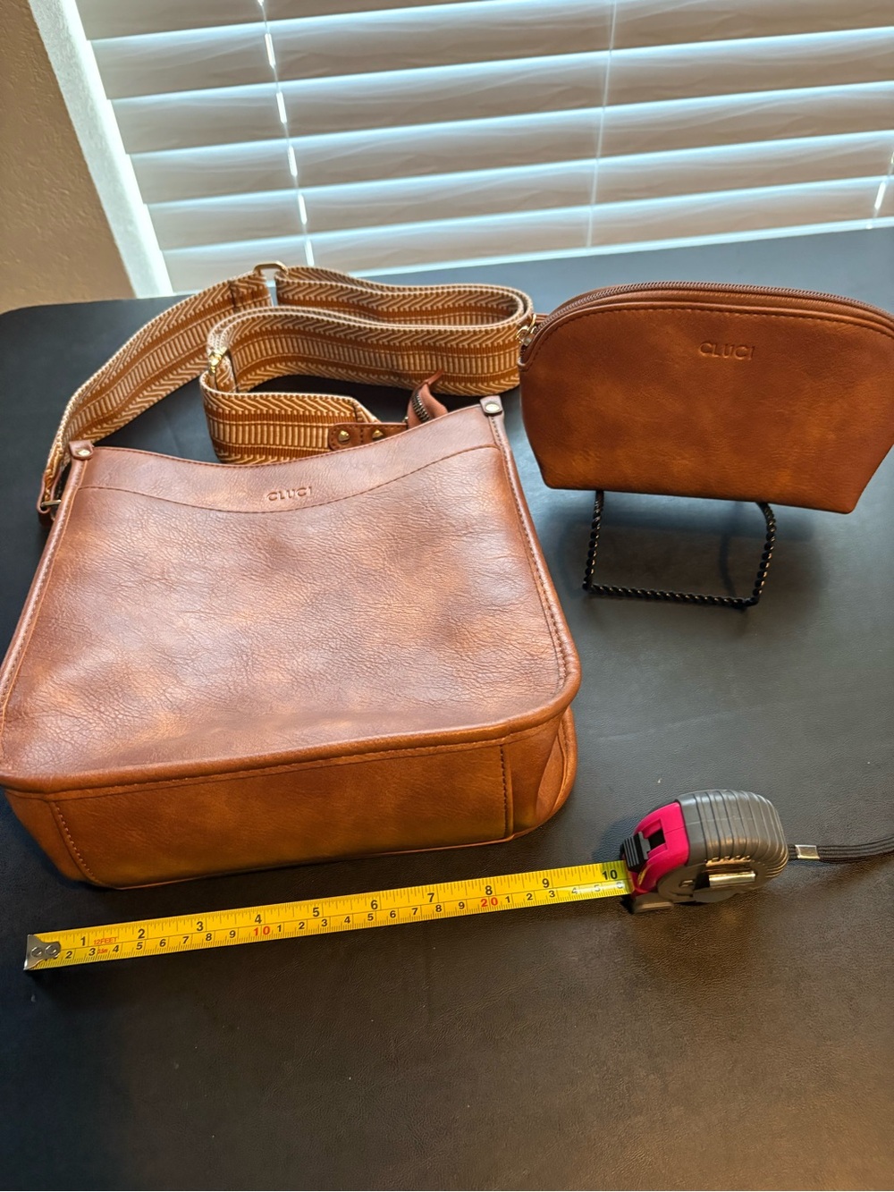CLUCI Medium Brown Crossbody with strap and small pouch.
